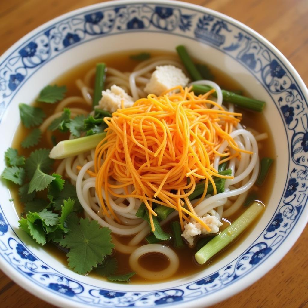 Bún riêu cua tại chợ Ga Buôn Ma Thuột với gạch cua vàng óng, rau sống tươi ngon và nước dùng đậm đà.